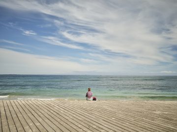 Women and dog enjoying the view of the ocean and Bathers Beach in Fremantle.