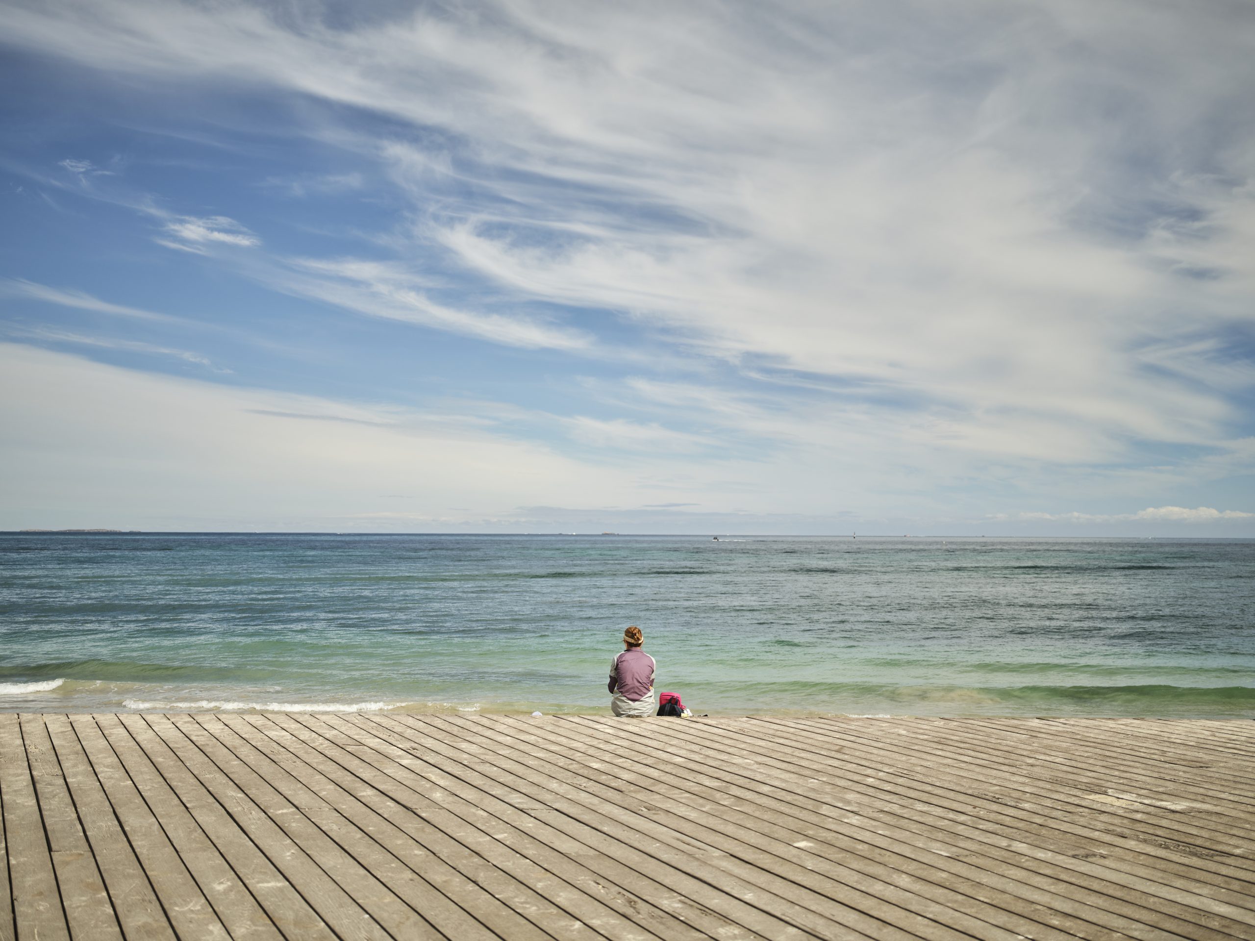 Women and dog enjoying the view of the ocean and Bathers Beach in Fremantle.