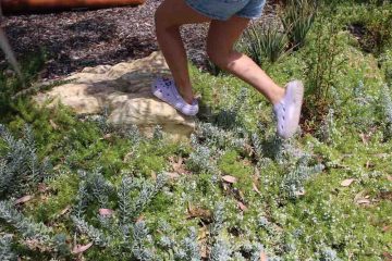 Child running through lush verge garden