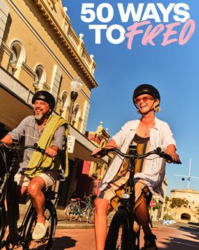 Two adults wearing helmets smile and ride bikes down a sunny street lined with historic buildings. The text 50 WAYS TO FREED appears in bold white and pink letters at the top right corner of the image.